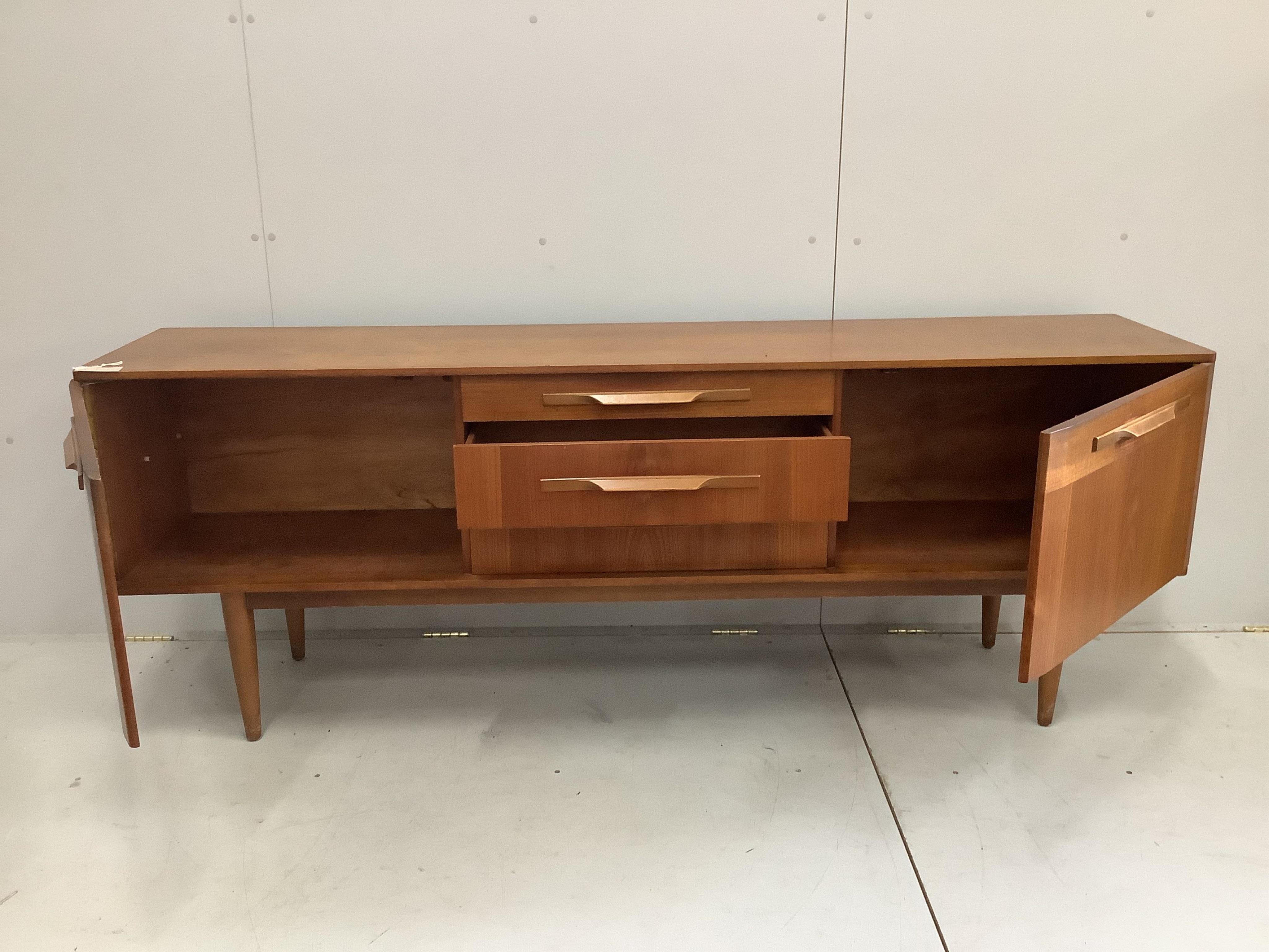 A mid century teak sideboard, width 198cm, depth 43cm, height 73cm. Condition - fair